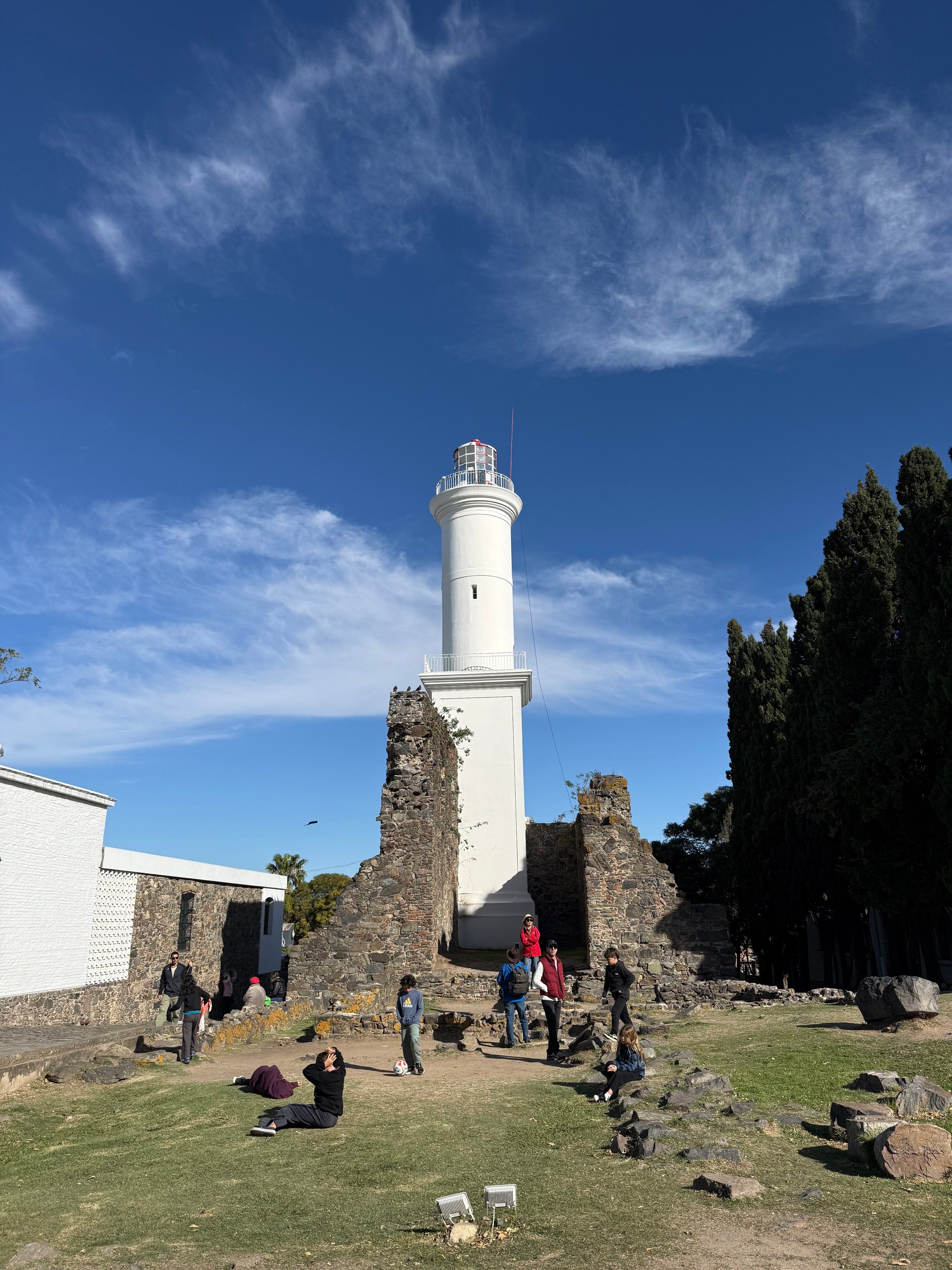 El faro de Colonia junto a las ruinas de piedra