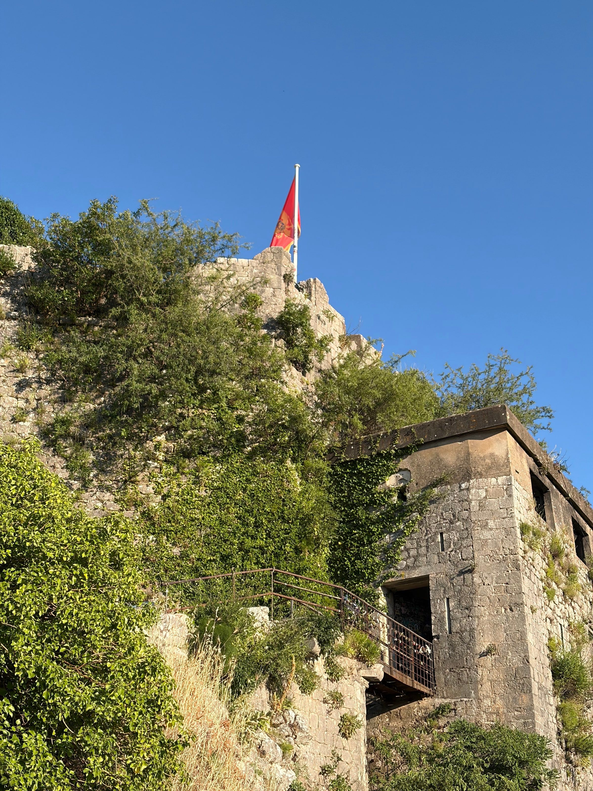 Ruinas de piedra de la fortaleza con una bandera roja