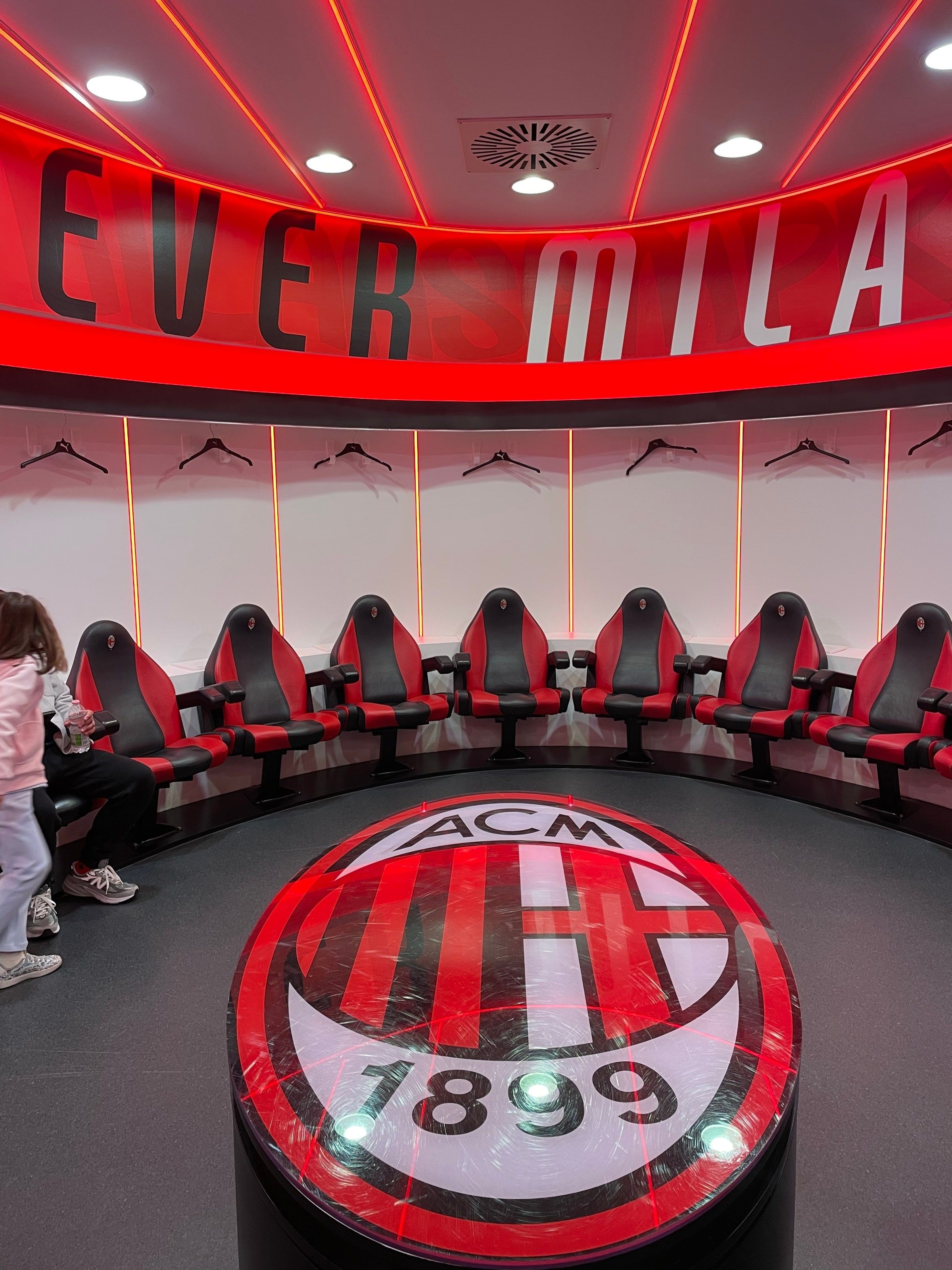 El vestuario del Milan en San Siro, con los sillones rojos y el escudo