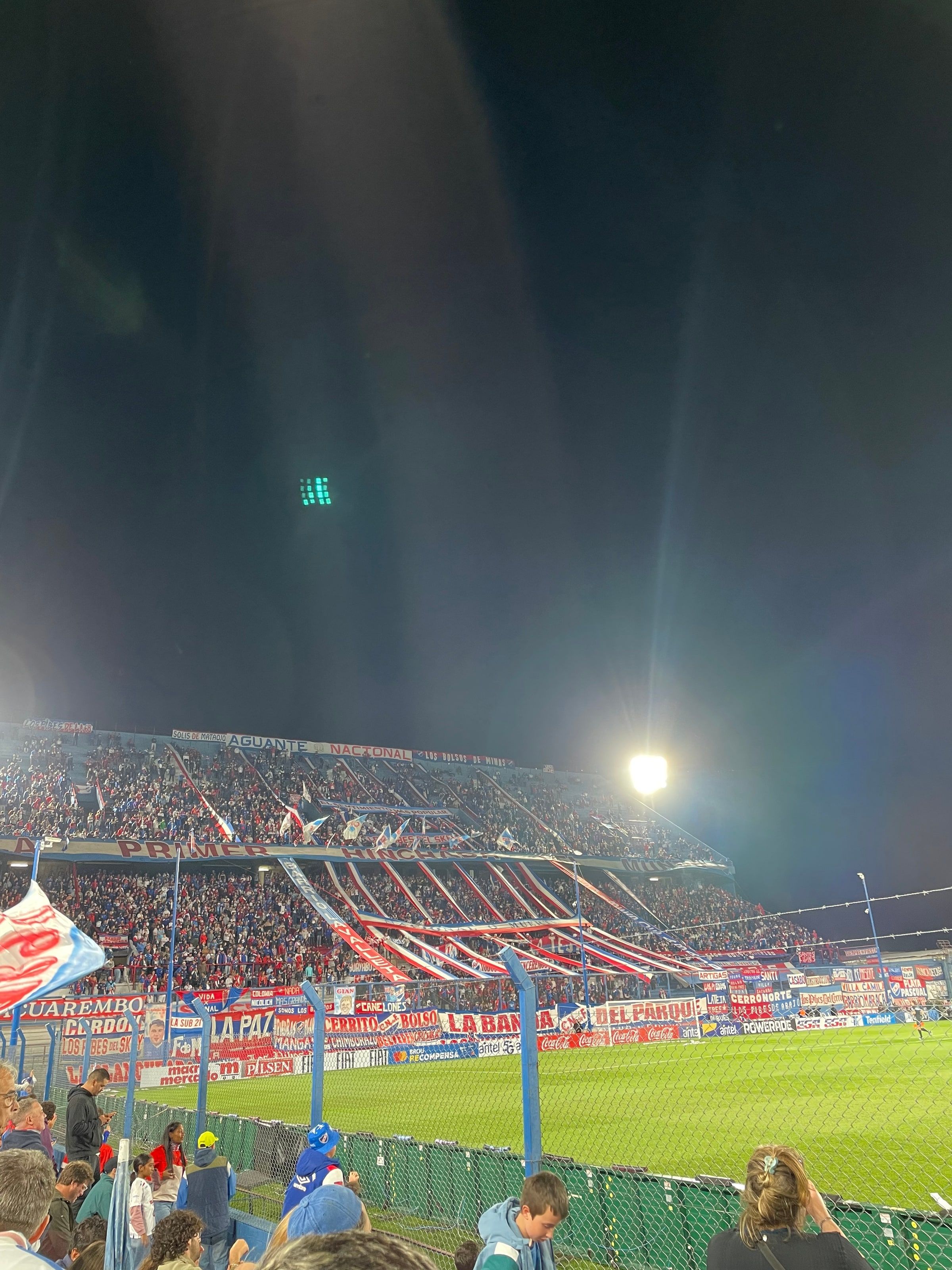 La hinchada de Nacional en la tribuna, de noche