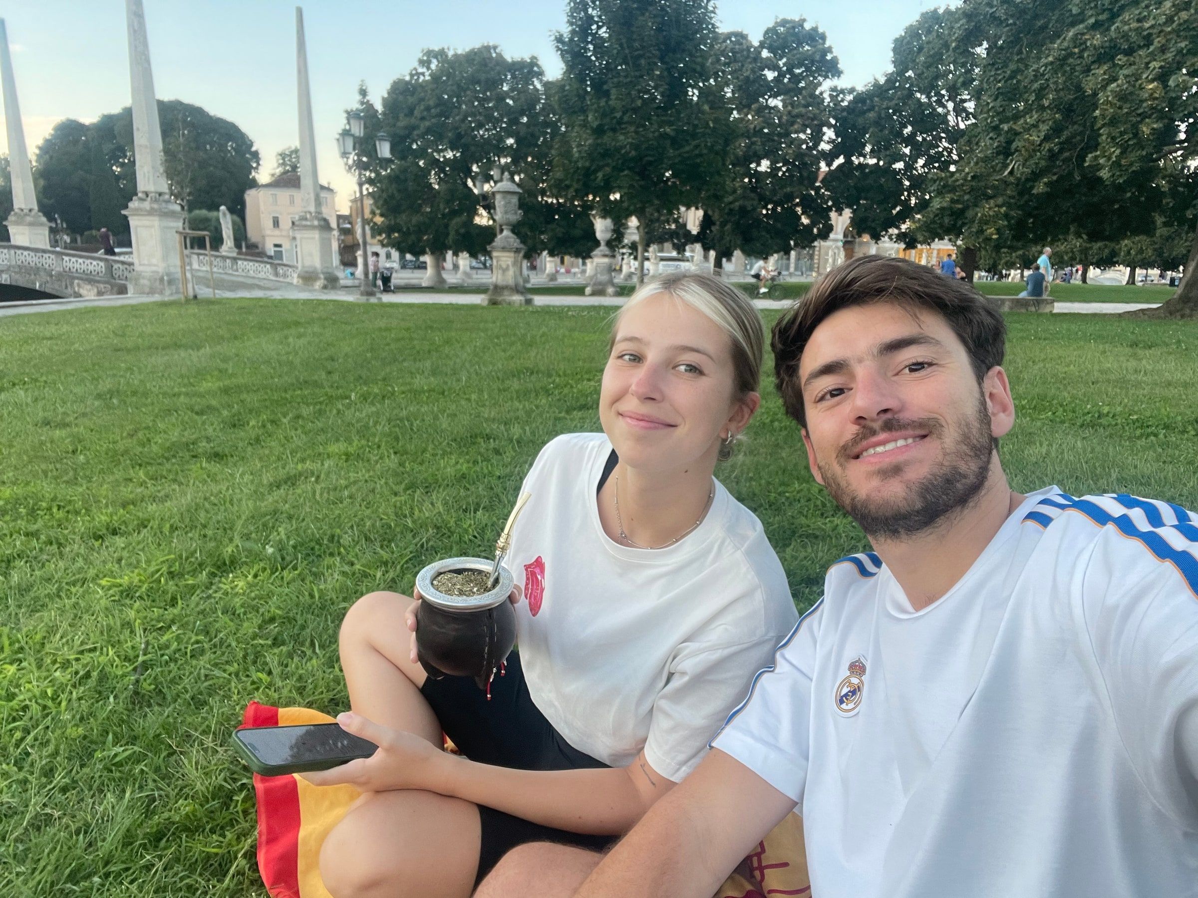 Tomi y su novia con el mate en el pasto de Prato della Valle
